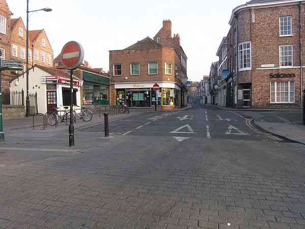The street extends from one 'No Entry' sign to the next.